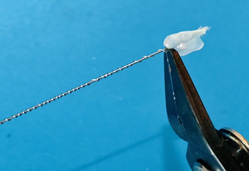 nichrome secured to a wire spool using a small vice and a bead of hot glue